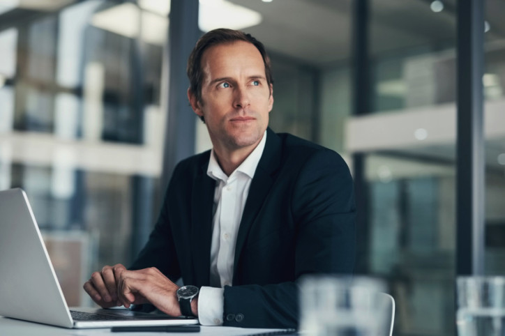 Eine Führungskraft schaut besorgt aus dem Fenster.