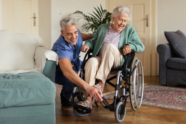 Caregiver doing regular check-up of senior client in her home.