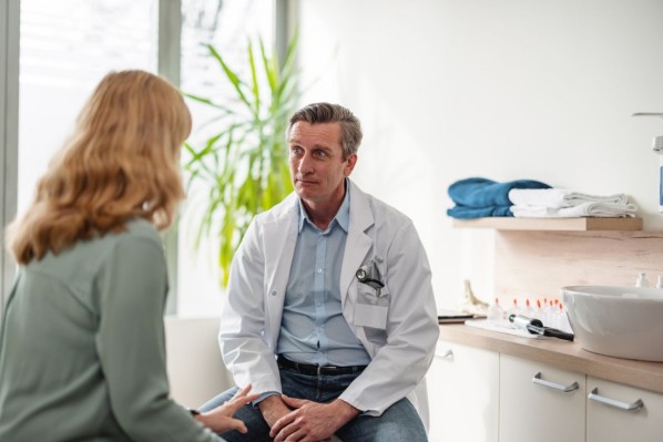 Mature Adult Woman Consulting With A General Practitioner In The Office