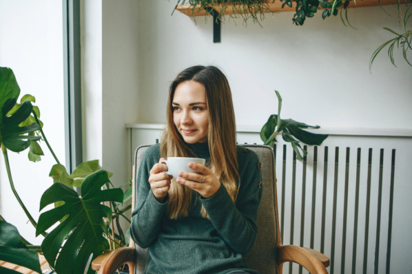 Eine junge Frau genießt einen Matcha-Tee