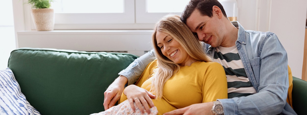 Werdende Eltern betrachten Babybauch