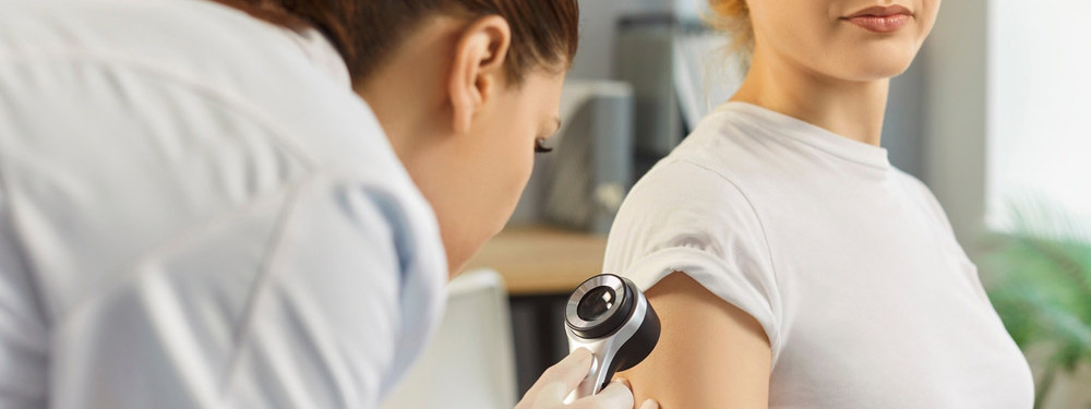 Hautärztin führt bei einer Patientin einen Hautcheck durch