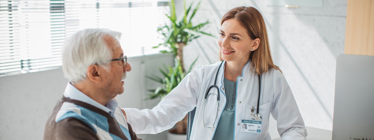 Eine Ärztin berät einen Patienten im Behandlungszimmer.