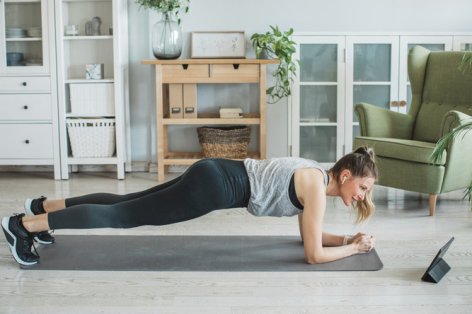 Women at home during pandemic isolation doing workout to stay in shape