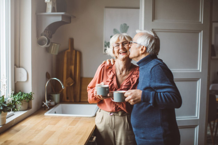 Eine verliebtes älteres Pärchen genießt gemeinsam eine Tasse Kaffee