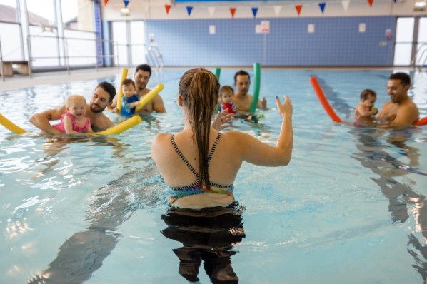 Vater mit Kind beim Babyschwimmen