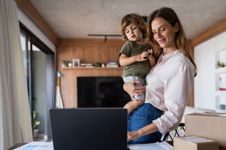 Brazilian mother running her e-commerce business from home while taking her of her son