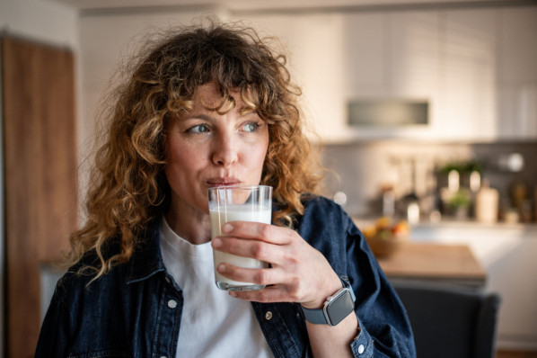 Eine Frau trinkt ein Glas Milch.