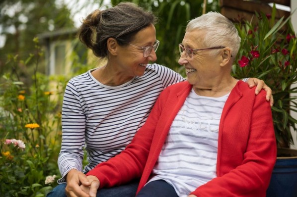 Senior woman with caregiver in the garden