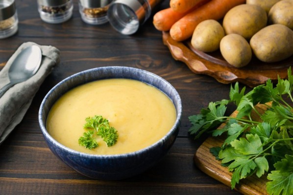 In traditional German and Austrian cuisine a potato soup is made from potatoes mainly. Some carrots might be added as well as some leek and celery. In case the consistency is more viscous, it is called potato stew. Sometimes it is served with creme fraiche or sour cream. Additionally bread or noodles can be served. The image might fit menu cards, cookbooks or prints for Restaurants.